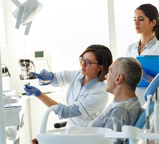 Patient in Owasso talking to dentist