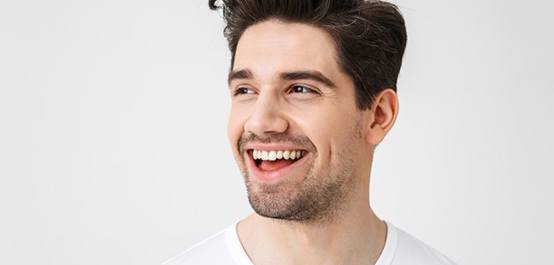 a man smiling with bright and healthy teeth