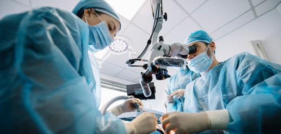 an oral surgeon performing dental implant surgery